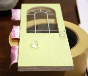Gluing door knobs to the Coventry Cottage dollhouse