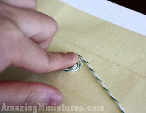 Use your finger to help anchor and guide the thread