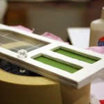 Gluing door knobs to the Coventry Cottage dollhouse
